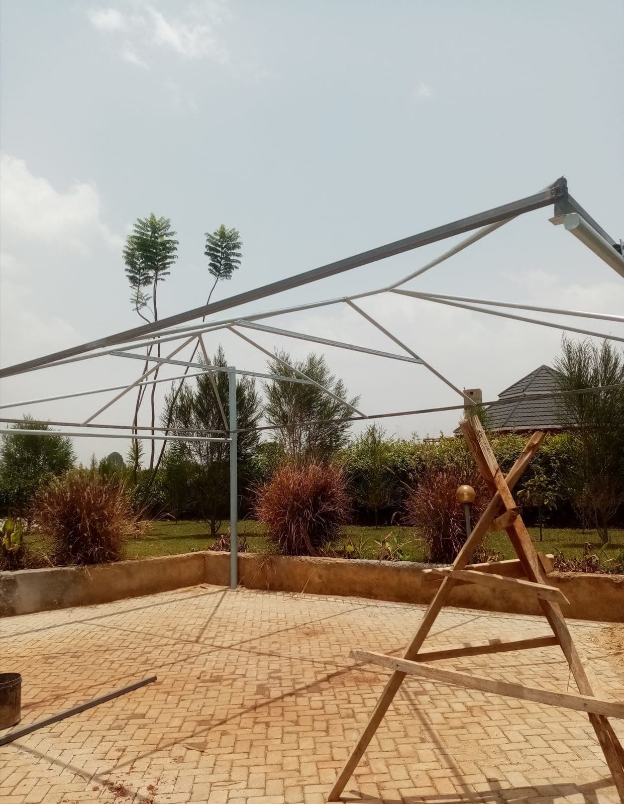 Bare steel cantilever frame for a car parking shade structure being erected at a residential property in Thika