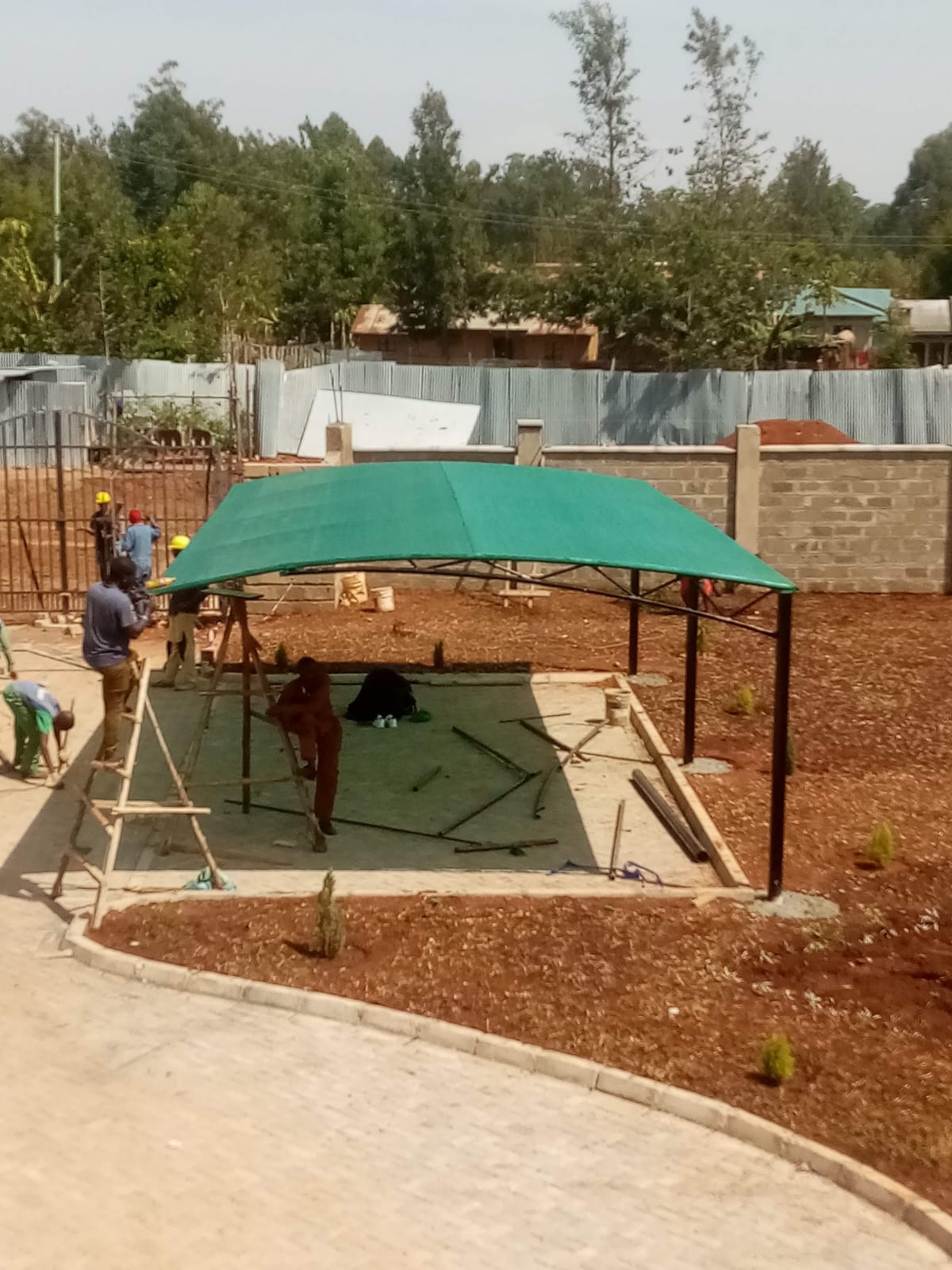 Car parking shade structure being installed at a residential property