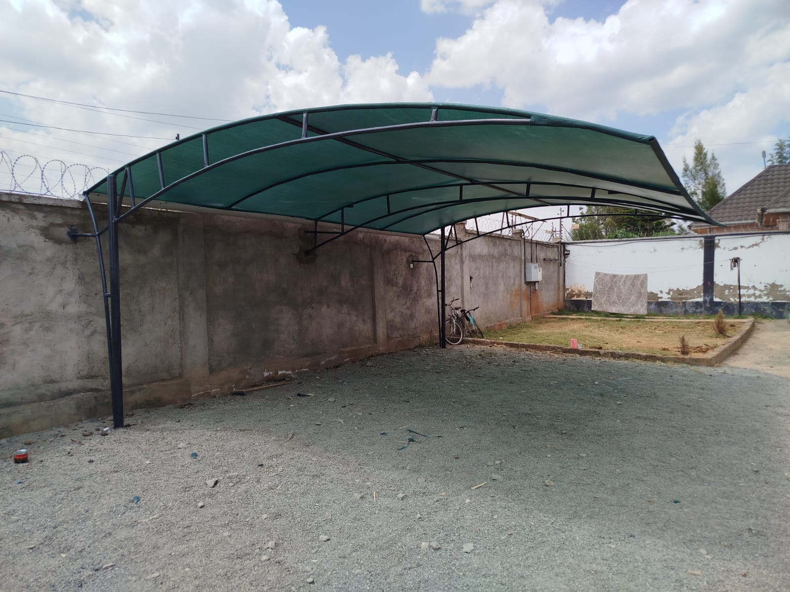 White arch car parking shade structure at a second Nairobi property