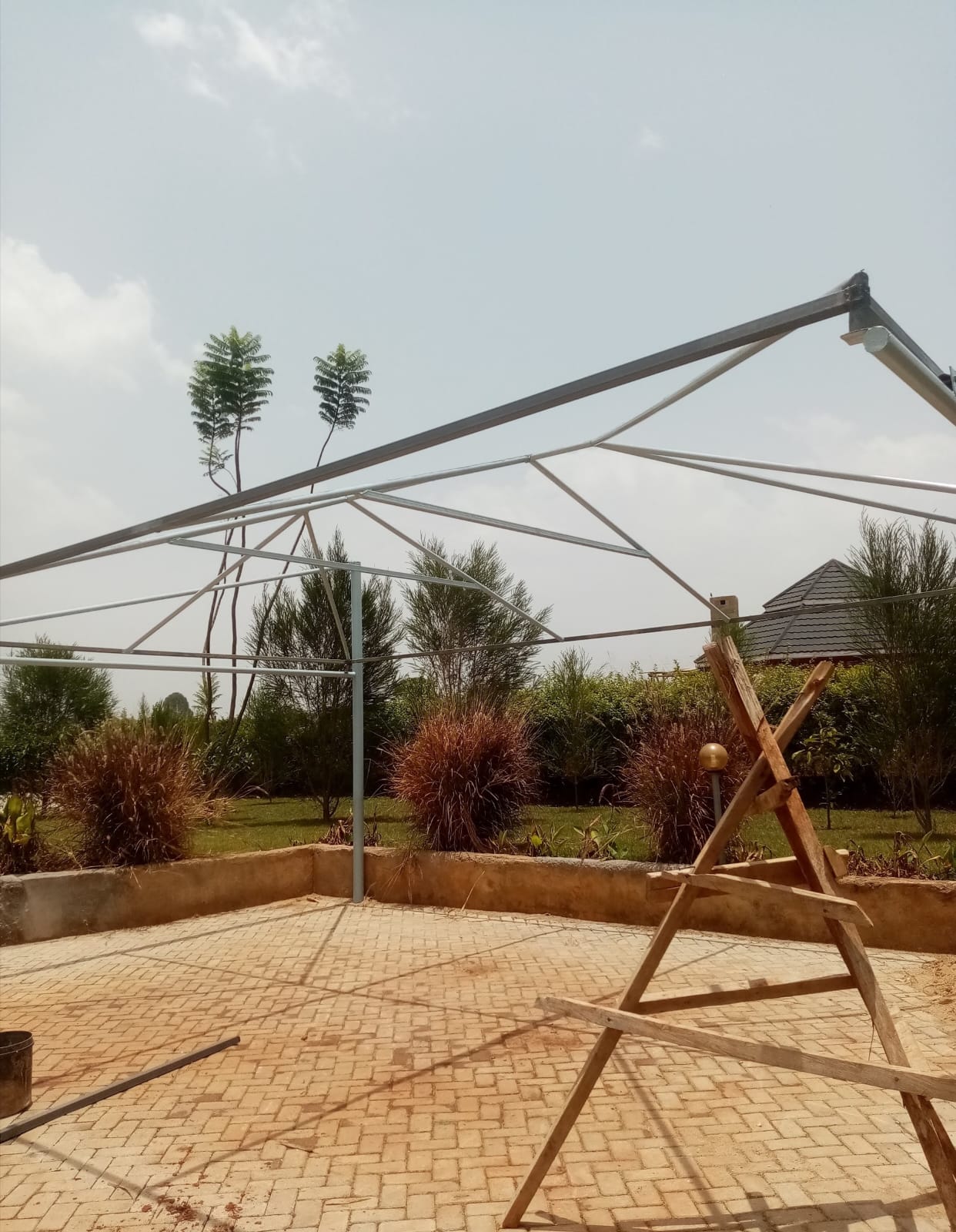 Bare steel cantilever frame for a car parking shade structure being erected at a residential property in Thika