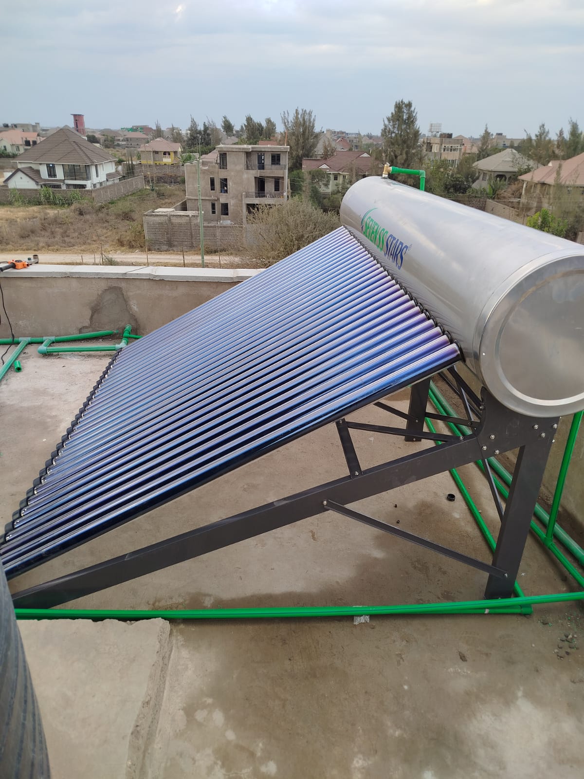 Finished 300L Seven SS Stars solar water heater on a rooftop overlooking a Katani housing development