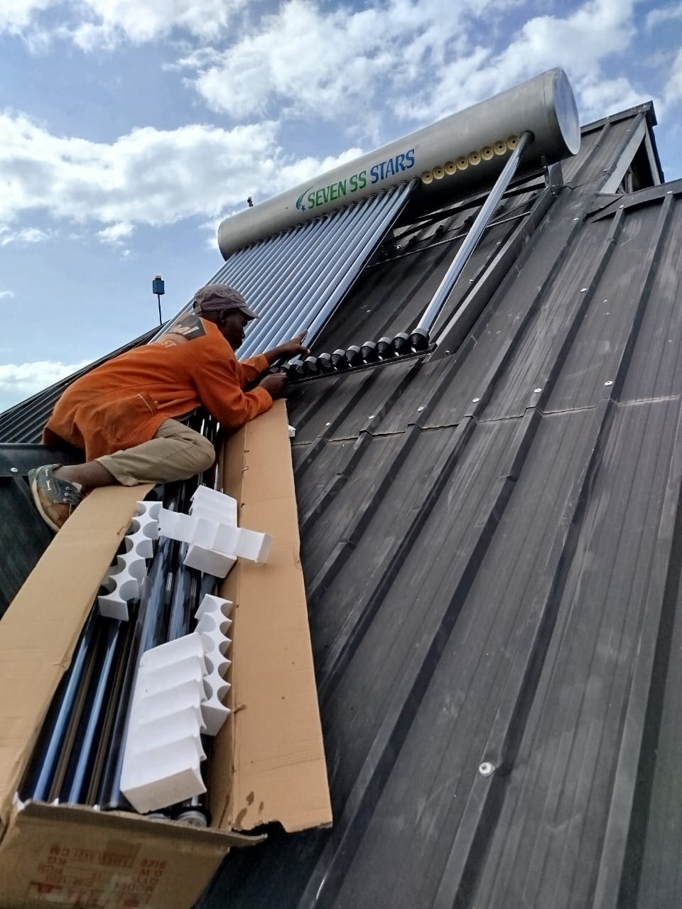 Elatec technician fitting solar water heater plumbing connections